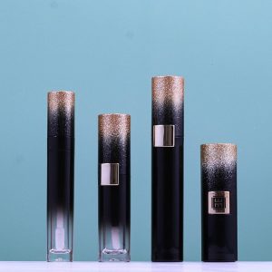 A Set Of Iridescent Mascara Tubes, A Centrally Pressable Lipstick Tube, And Liquid Eyeliner Tubes